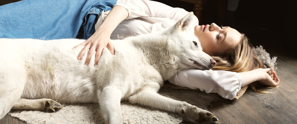 Woman laying down with dog